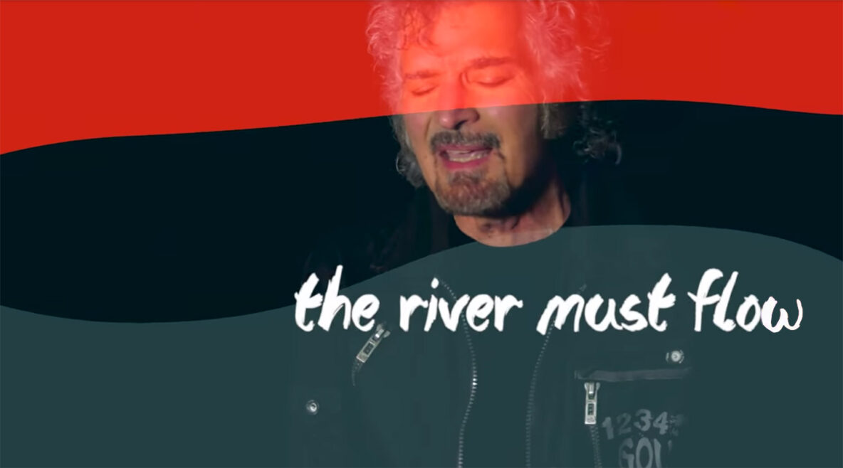 gino vannelli singing in "the river must flow" music video